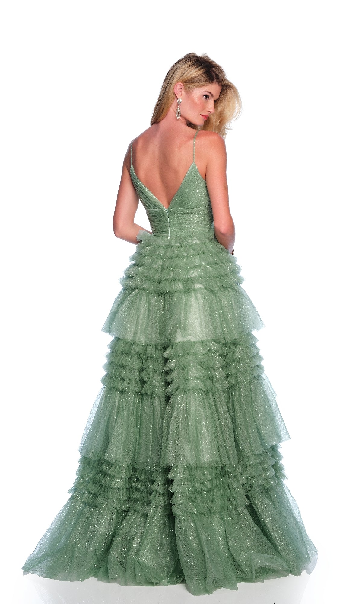 Woman in the Dave & Johnny 11994 Green Glitter Prom Dress with spaghetti straps and a ruffle tiered A-line skirt, standing and facing away against a plain white background.